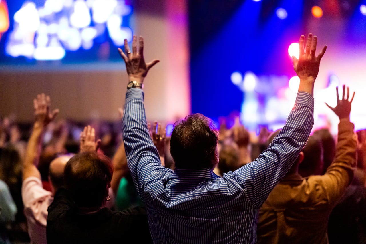 Energizing scene of a crowd enjoying a live music performance with colorful stage lights.